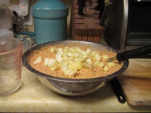 Adding cut apple to the batter;  photo by Bea Garth